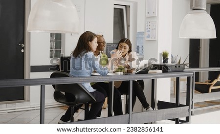 Multiethnic group of employees discussing new strategy for business development in coworking space. Professional women thinking about corporate investment to increase profit in office.