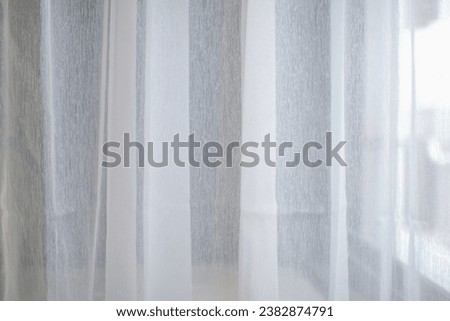 White chiffon curtains for interior design decoration. Modern lifestyle background and texture. Satin sheer curtains with morning sunlight Royalty-Free Stock Photo #2382874791
