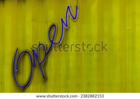 Open neon sign on the shop door in Brazil