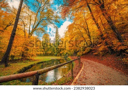 Mountain trail with calm lake, amazing autumn colors of leaves trees, sunny dream landscape. Beauty of nature concept background. Adventure hiking freedom stunning forest natural scene. Majestic view Royalty-Free Stock Photo #2382938023