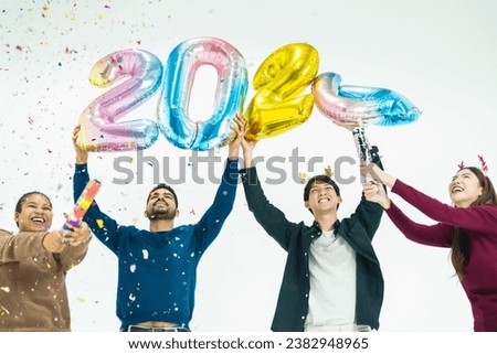 group of people holding fantasy color balloons bubble of the number 2024 for the new Year. men and women standing on a white background. celebration of happy new year Party