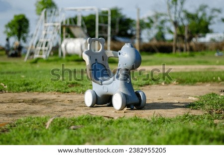 Children's bicycle in the shape of a cartoon dinosaur in the playground