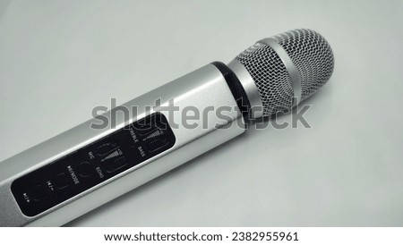 Silver and gold microphone with Bluetooth connection for karaoke music at home, isolated on a white background