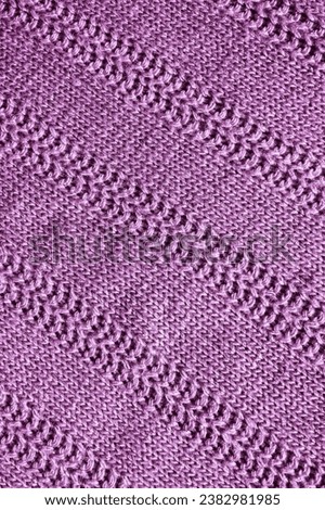 lilac knitted texture. Abstract background, pattern, ornament. Detail of a warm winter sweater.