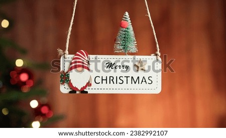 Merry Christmas patch with blurred tree in the background  Royalty-Free Stock Photo #2382992107