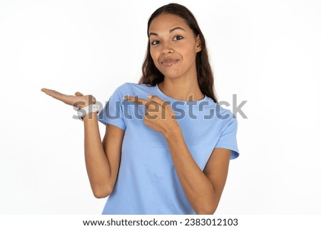 beautiful dark haired woman pointing and holding hand showing adverts