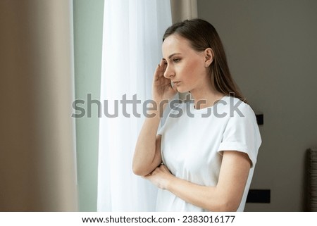 A worried, frustrated young woman feeling depressed and lonely, suffering from a headache after an emotional trauma, in need of psychological help Royalty-Free Stock Photo #2383016177