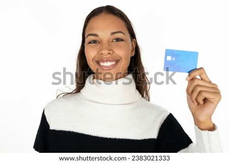 Photo of happy cheerful smiling positive young beautiful business woman wearing striped sweater recommend credit card