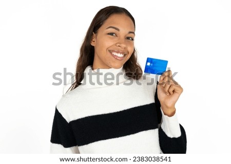 Close up photo of optimistic beautiful dark haired woman hold card