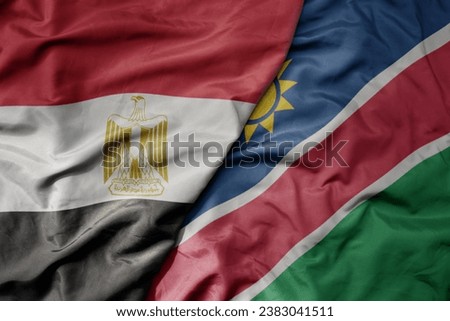 big waving national colorful flag of egypt and national flag of namibia . macro