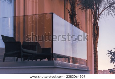 New modern glass balcony railing. Balcony railings made of glass and stainless steel. Apartment with glass balcony terrace of modern architecture house by the sea Royalty-Free Stock Photo #2383064509