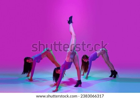 Beautiful, artistic, elegant women with slim bodies dancing high heel dance over pink studio background in neon light. Concept of hobby, contemporary dance style, art, beauty, creativity, elegance