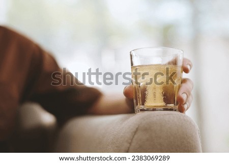 Fizzy tablet dissolving in glass of water in hand of young man Royalty-Free Stock Photo #2383069289