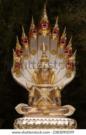 Multi-colored jade Buddha statue with ornaments and Naga Prok Authentic Thai Buddhist art