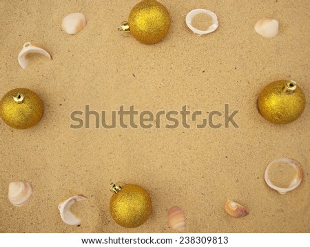 christmas balls in sand   