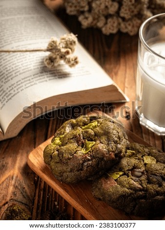 Cookies are arranged messily on a wooden placemat, isolated with a wooden table background.