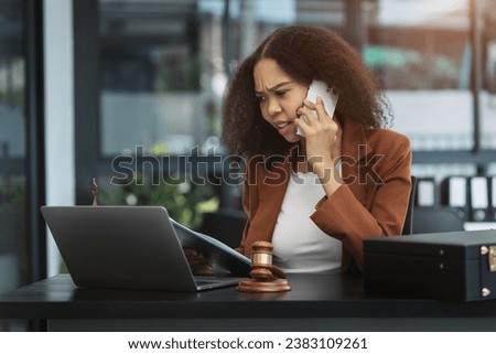 Female Legal counsel working with paperwork on his desk in office workplace working with tablet computer. Justice and law concept.