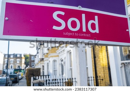 Estate agent Sold sign on residential street in SW6 area of south west London
