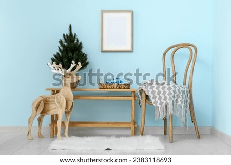 Interior of living room with chair, table and Christmas tree