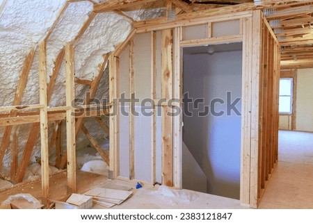 Spray foam insulation is used to insulate wall of an under construction site new home Royalty-Free Stock Photo #2383121847