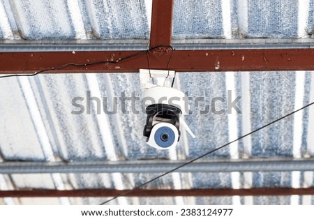 Closed-circuit camera, small CCTV for to wall house, hanging on attic beams in garage. Record events such as traffic, accidents. Also prevent thief. Modern technology is widely. Safety protection.