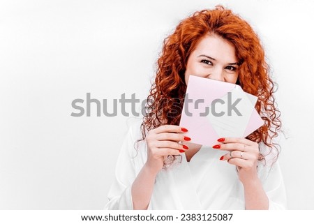 A gift certificate to a beauty salon for laser hair removal. Hair removal services, self-care and beauty. Gift certificate in the hands of a red-haired girl with glasses