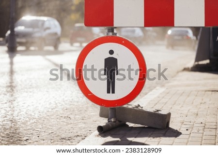No pedestrian road sign. No walk icon. Pedestrian prohibited sign. Road construction site background. Street rebuilding landscape. Walking not allowed. Traffic disruptions.