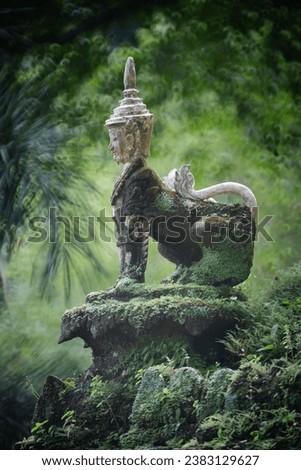 Mythological Creatures, Angel, Guardian statue at Wat Palad, or Wat Pha Lat temple the secret hidden temple nestled in the jungle on the Doi Suthep Mt. travel destination of Chiang Mai, Thailand. Royalty-Free Stock Photo #2383129627