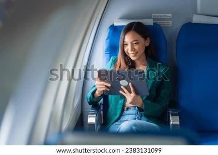 Female airplane passengers asian chinese people Entrepreneurs on Flight, Venturing Overseas Investments. Global Business Expansion, Foreign Markets, Strategic Financial Moves. Women in Business Suits Royalty-Free Stock Photo #2383131099