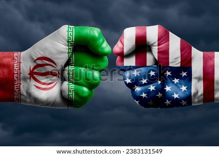 IRAN vs USA confrontation, religious conflict. Men's fists with painted flags of IRAN and USA