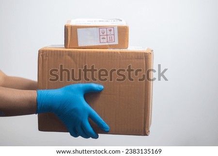 Hand holding a parcel box on a white background