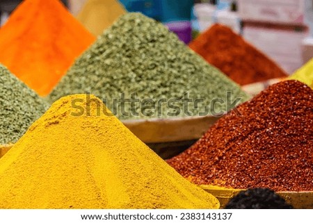 Poles of multicolor spices at Egypt Bazaar (Misir Carsisi) in Istanbul, Turkey (Turkiye). Spices Market with colourful mood. Selected focus, colorful background