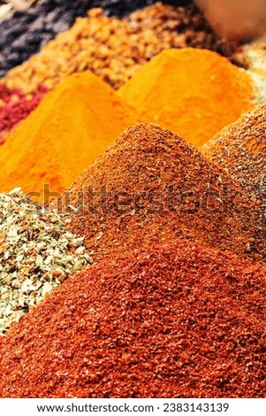 Poles of multicolor spices at Egypt Bazaar (Misir Carsisi) in Istanbul, Turkey (Turkiye). Spices Market with colourful mood. Selected focus, vertical shot, colorful background