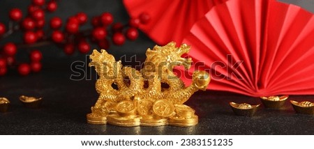 Golden figurine of Chinese dragon on dark background