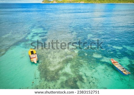 Bird eye drone of baie lazare beach, docking fisherman boats on low tide, turquoise water, sunny day, Mahe Seychelles 1