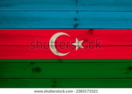 colored national flag represents Azerbaijan's sovereignty and independence as nation on plank wall, concept unique cultural and political identity, tourism, emigration, economy and politics