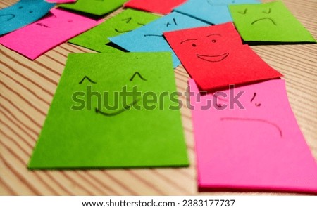 many colorful sticky notes with a face expression