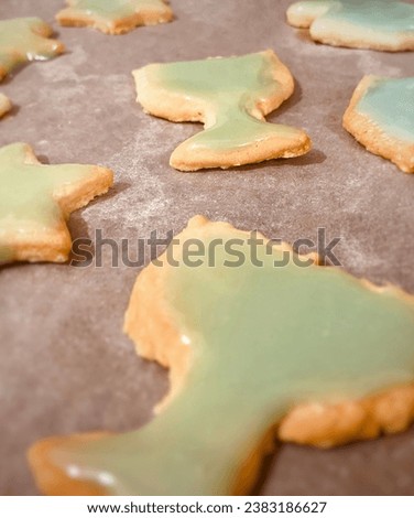 Chanukah sugar cookies with green icing stock photo. Menorah cookies and star cookies on cooking sheet. Baked cookies.