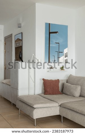 Soft corner sofa with pillows and lamp in luxury apartment