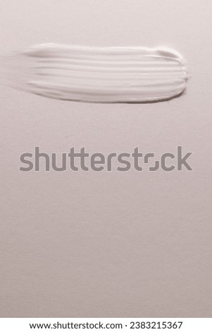 Vertical image of beauty product white cream smudge with copy space on white background. Health and beauty, beauty product, make up and colour concept.