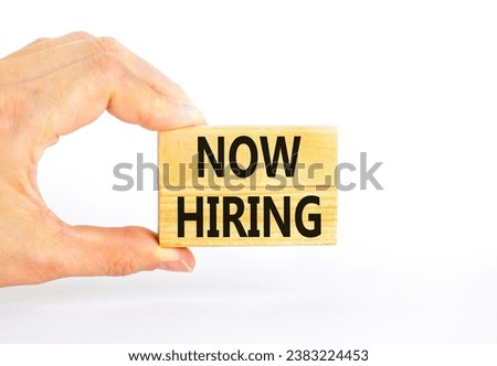 Now hiring symbol. Concept words Now hiring on beautiful wooden block. Beautiful white table white background. Businessman hand. Business marketing, motivational now hiring concept. Copy space.