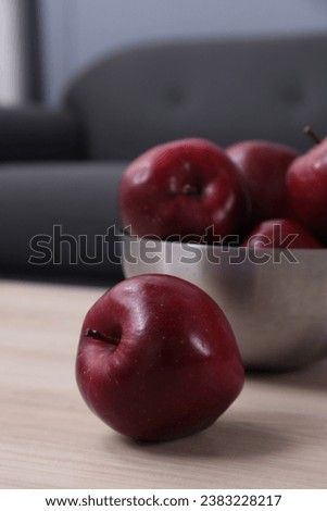 Red apples on wooden table indoors, closeup