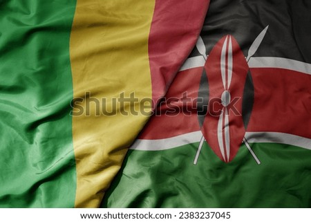 big waving national colorful flag of mali and national flag of kenya . macro