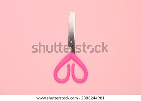 Scissors for creativity on a pink background