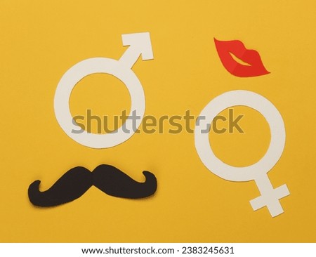 Paper cut Male gender symbol with mustache and female gender symbol with lips on yellow background