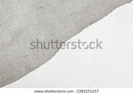An old wall with a cracked texture is decorated with cement sand mortar. Diagonal crack on the decoration of the white wall.