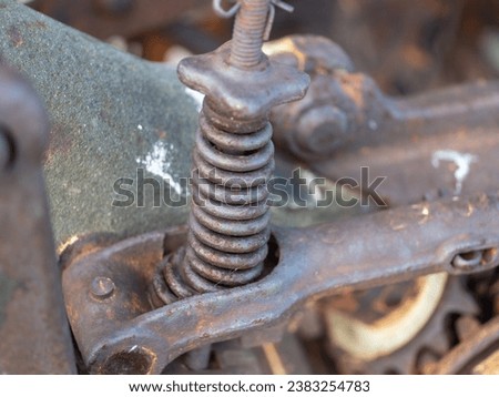 Rusted old spring and tractor components