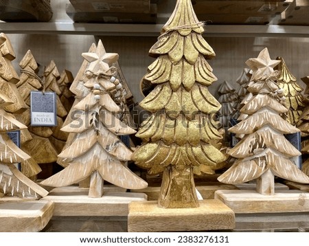 A shelf full of decorative wooden Christmas trees.