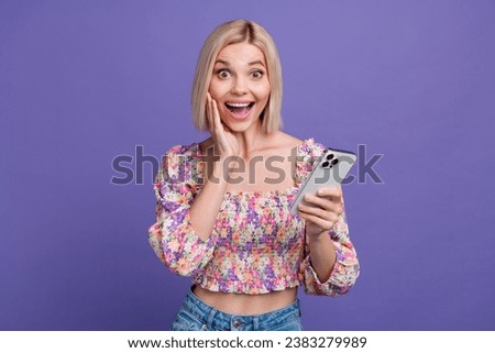 Photo of sweet impressed woman dressed flower print blouse texting apple samsung iphone device isolated purple color background