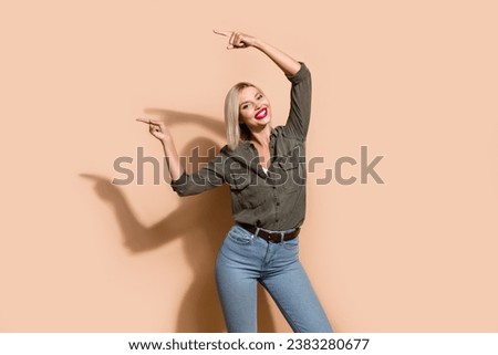 Photo of amazing beautiful business lady indicating index fingers empty space novelty wear shirt jeans isolated beige color background